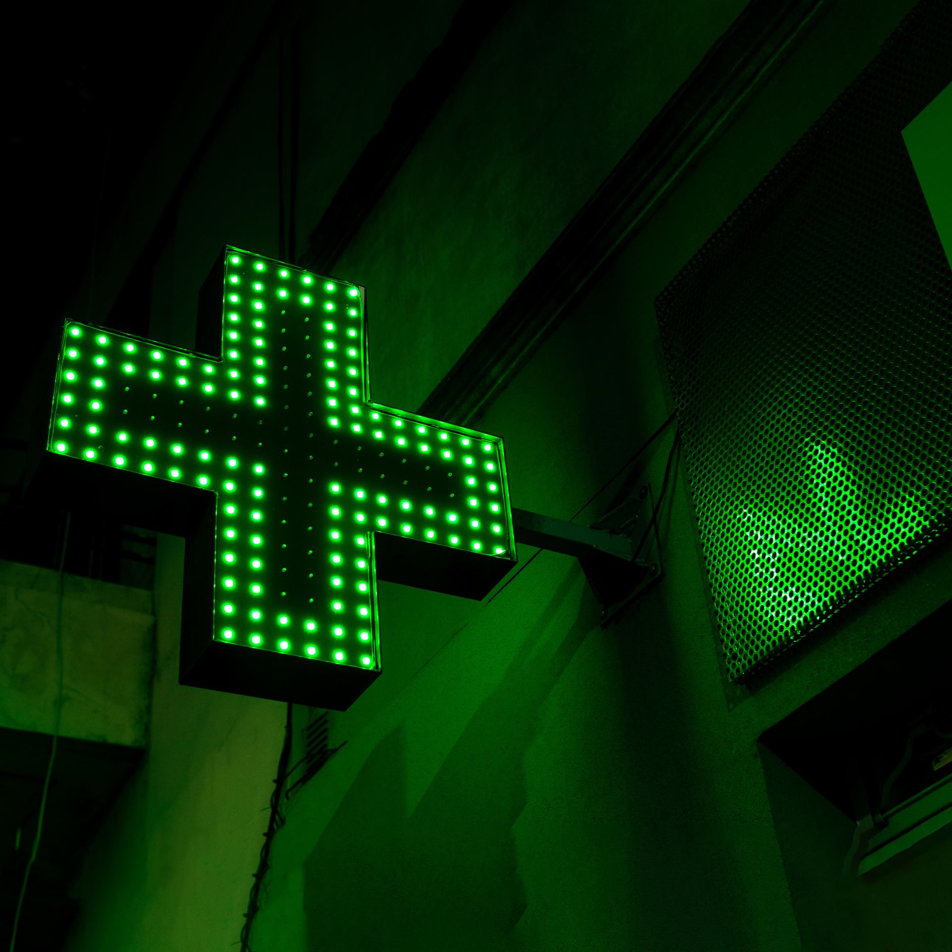 a neon pharmacy sign